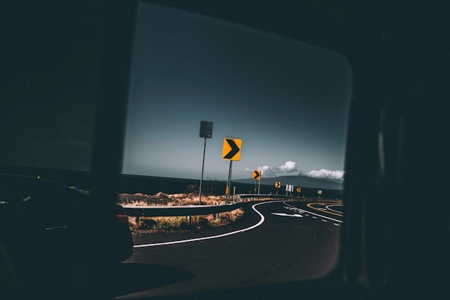 Winding road with curve warning signs on Maui, Hawaiʻi